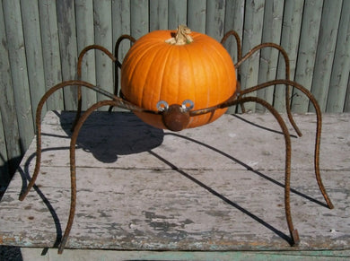 This wrought iron spider could hold a pumpking or a gazing ball Measures 11