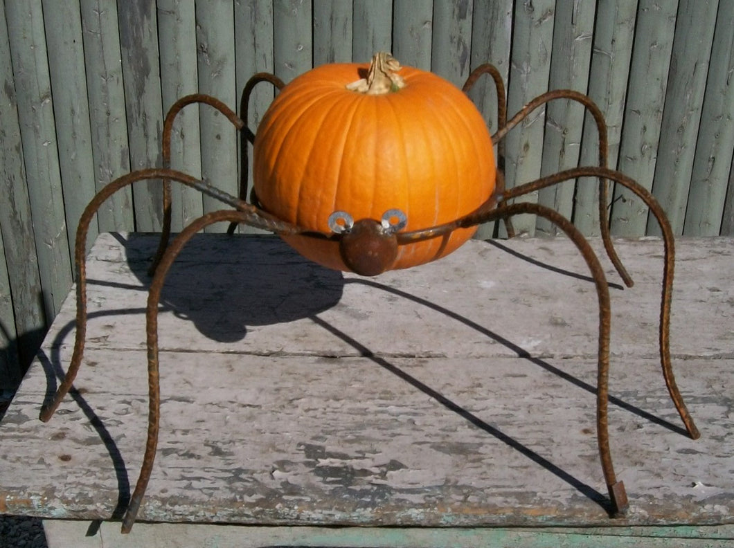 This wrought iron spider could hold a pumpking or a gazing ball Measures 11