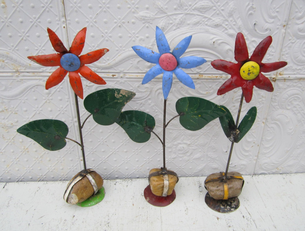 These star flowers are made from recycled metal They have a rock on the bottom so they will free stand Measures 22